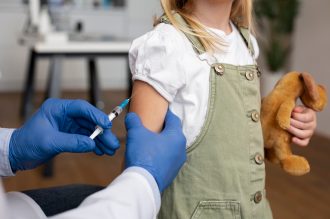 male-pediatrician-administering-vaccine-in-his-office